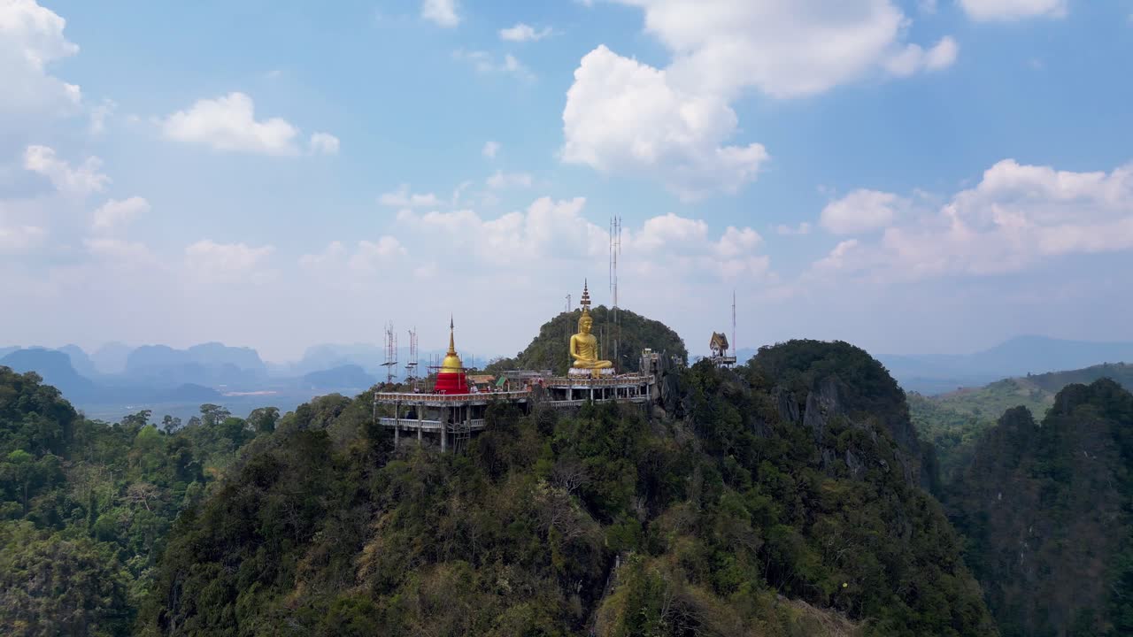 Aerial view of Tiger Cave Temple in Krabi, Thailand, perched on a mountain with a golden Buddha and stunning panoramic views