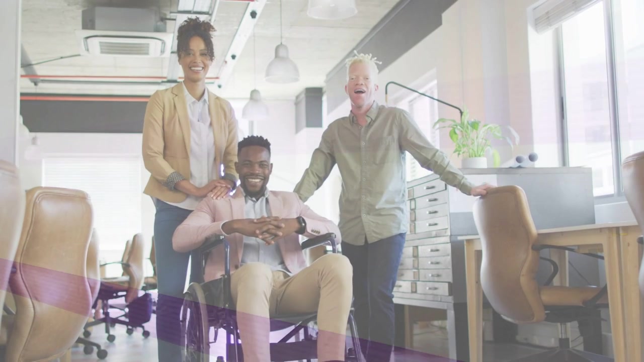 Camera shooting, work team posing, showing unity, man in wheelchair adjusting, hue bands shifting