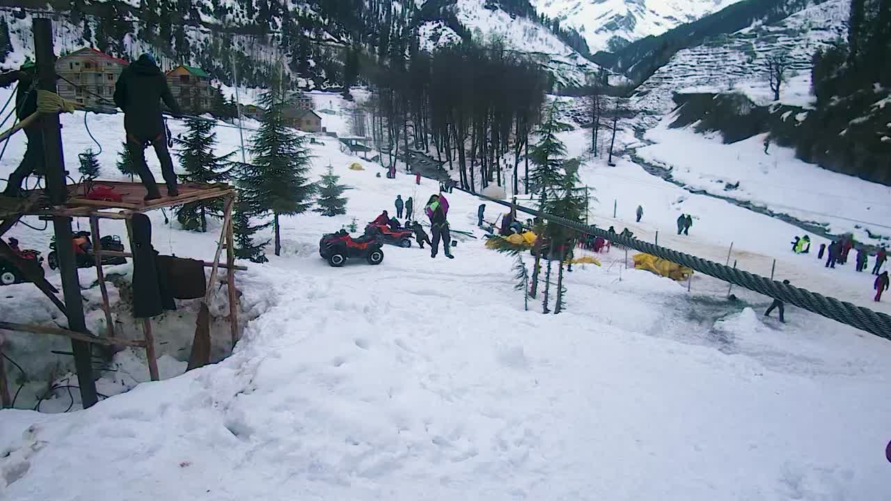 girl doing ropeway sliding adventure at snow cap mountains at day video is taken at manali at himachal pradesh india on Mar 22 2023