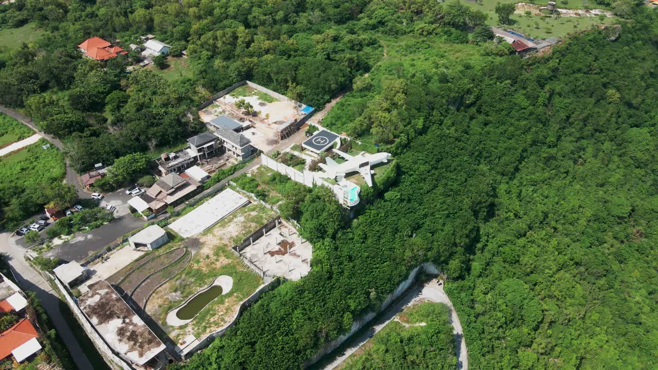 A beautiful, green top view of the South Bali cliffs, showcasing a private area for luxury tourism and hidden gem villas, where the famous private jet villa is located.