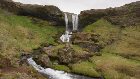 a beautiful waterfall flowing strongly on a cloudy day in iceland