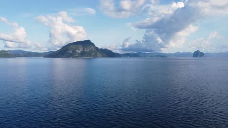 Aerial-seascape-of-cumulus-clouds-on-a-clear-blue-sky-at-Bacuit-bay-archipelago,-El-nido