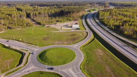 roundabout with a highway interchange on spring in katlakalns, latvia. aerial drone shot