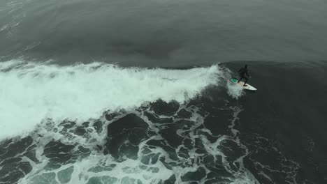 Aerial-close-up-of-Surfer-Riding-wave,-Pichilemu,-Chile