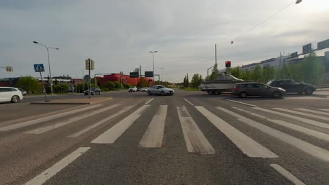 front view of a car waiting at an intersection for the traffic lights to change in helsinki, finland