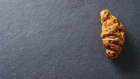 video of close up of croissant on gray background
