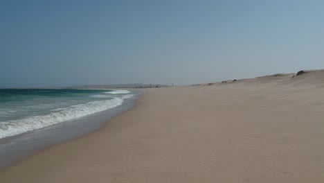 Drone-flying-at-low-altitude-across-beautiful-white-sand-beach-and-turquoise-water-near-Sur-in-Oman