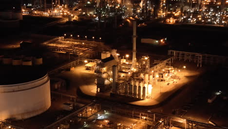 aerial view of oil refinery process plant at night, establishing view