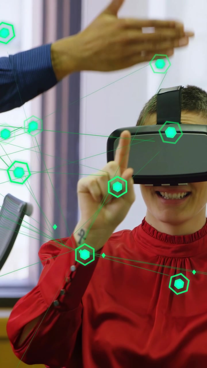 Vertical video: Woman wearing VR gear after peer guide, tapping green hex UI reacting for tech demo