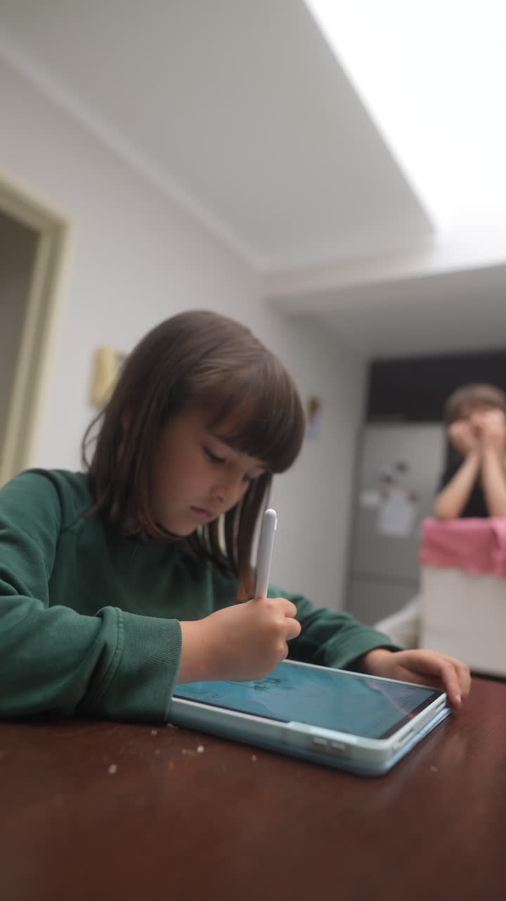 Girl Drawing on Tablet in Kitchen