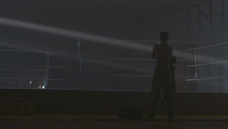 man preparing for boxing workout in gym