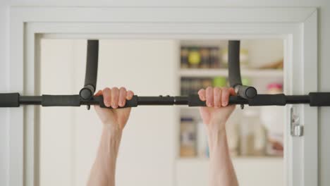 Man-doing-chin-ups-at-home