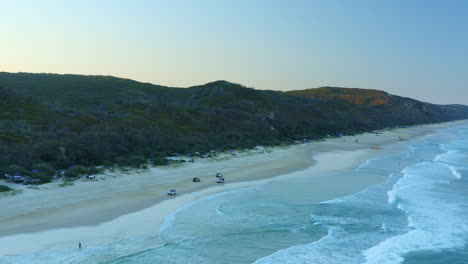 Ute-Camper-Trucks-Drive-on-Sandy-Beach-at-Double-Island-Point,-Australia