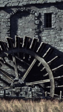 close-up of a water wheel in a medieval stone building