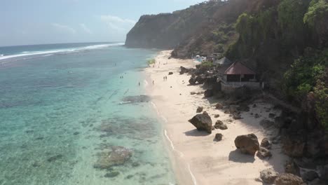 pantai melasti beach bali, indonesia flyover beautiful sandy tropical white sand beach