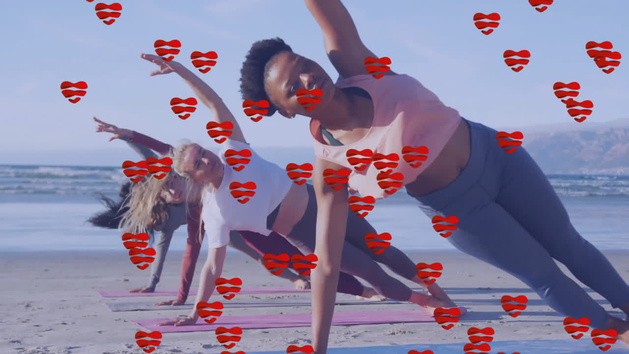 Women practicing yoga on beach with red heart animation overlay