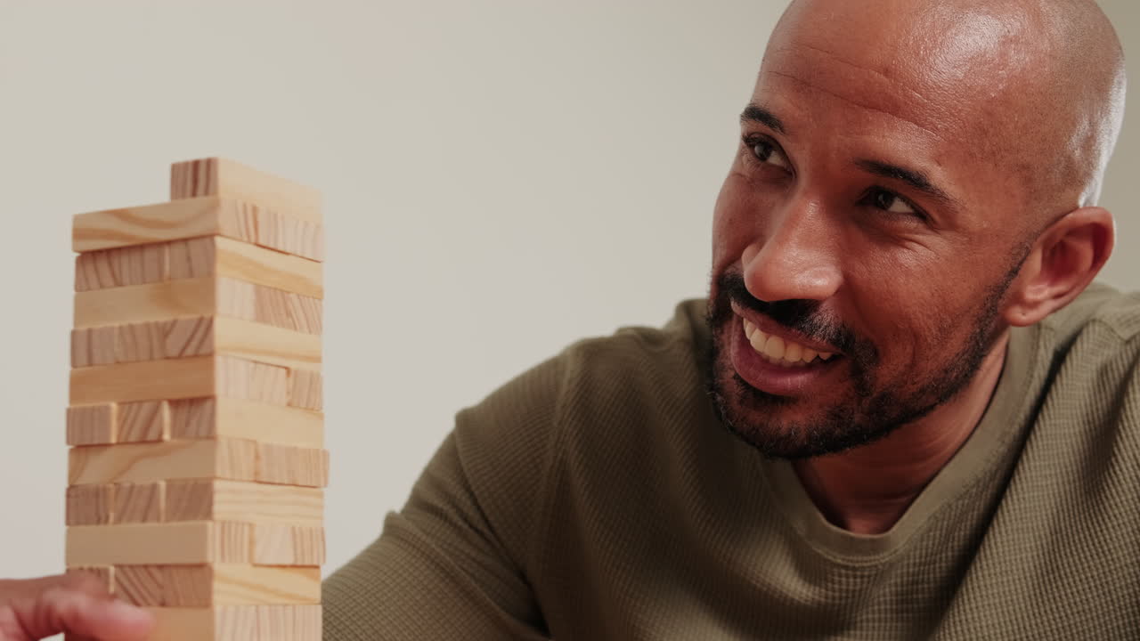 Man Playing Jenga at Home