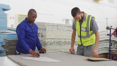 workers looking at a pattern on a cardboard