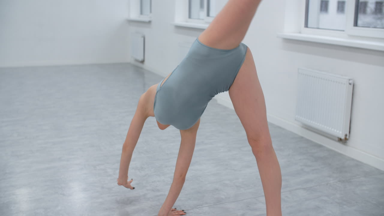 Gymnast performing acrobatics with a ball