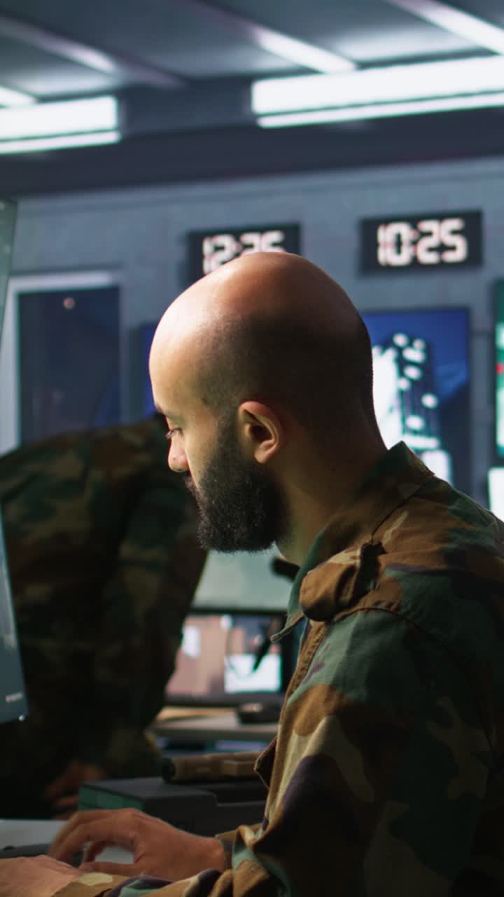 Vertical video Man looking at screens in military HQ base intercepting ballistic rockets