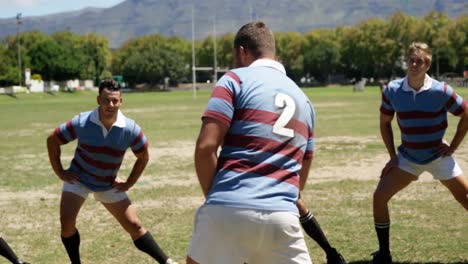 Rugby-players-performing-stretching-excise-in-the-field-4K-4k