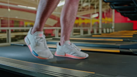 man exercising on treadmills, doing fitness exercise