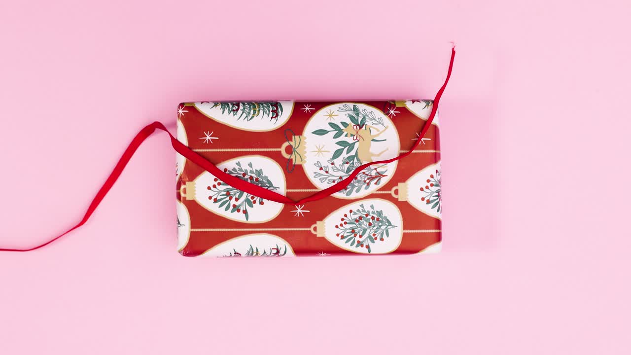 regalar cinta roja en el regalo de navidad en el tema rosa pastel. stop motion