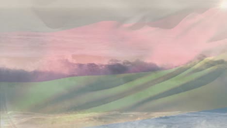 digital composition of germany flag waving against aerial view of waves in the sea