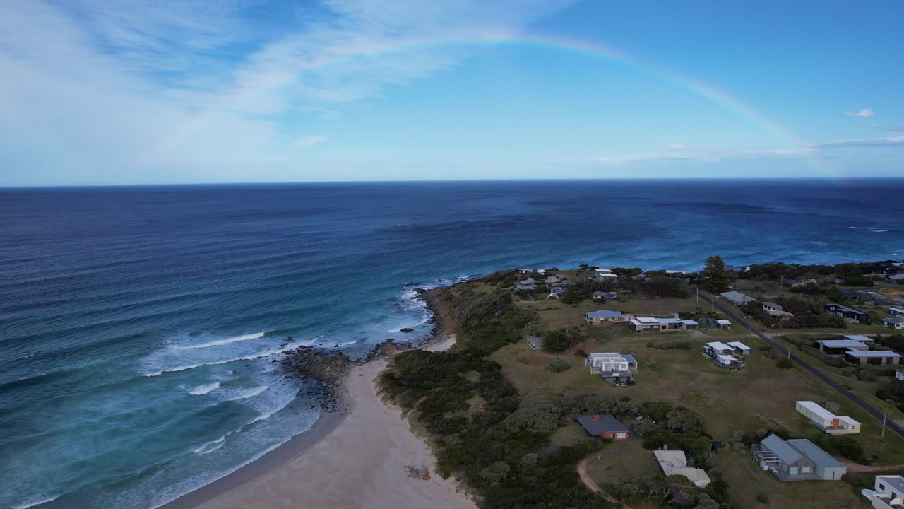 Scenic Coast Of Falmouth With Rainbow Over Seascape In Tasmania, Australia - Drone Shot