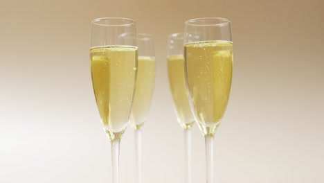 video of champagne in glasses on beige background