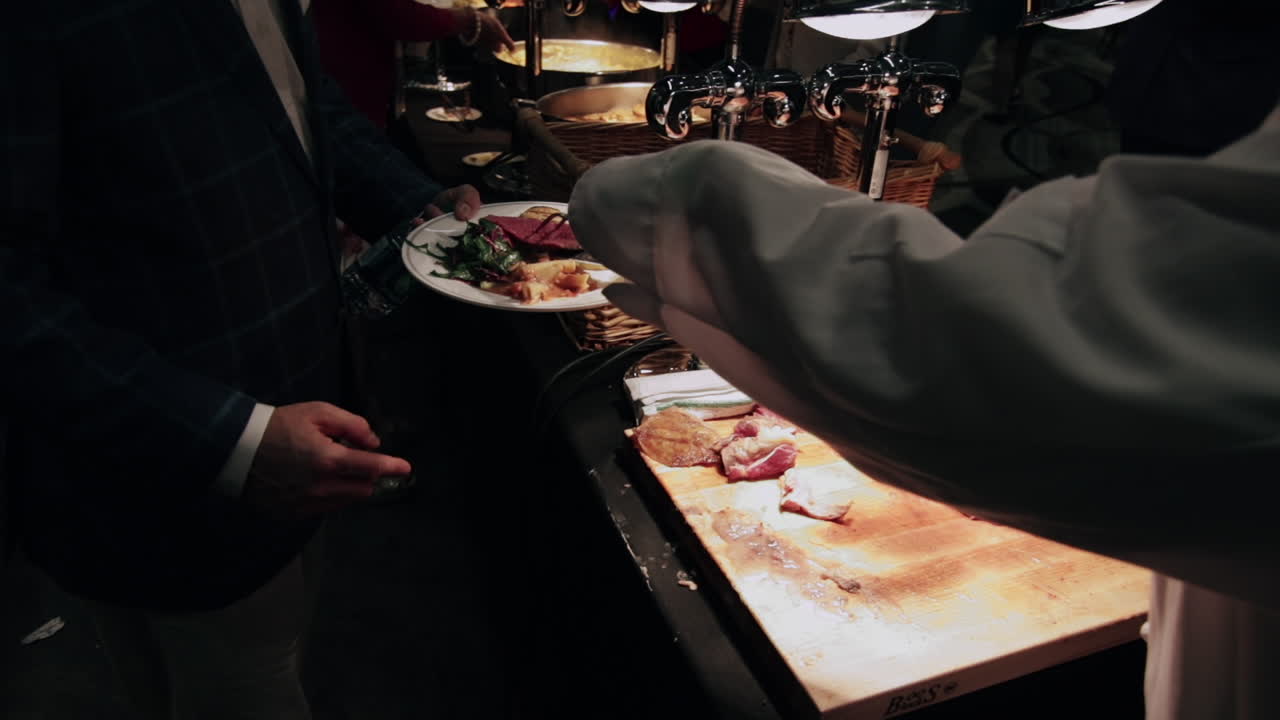 Meat carved by chef in a buffet in slow motion
