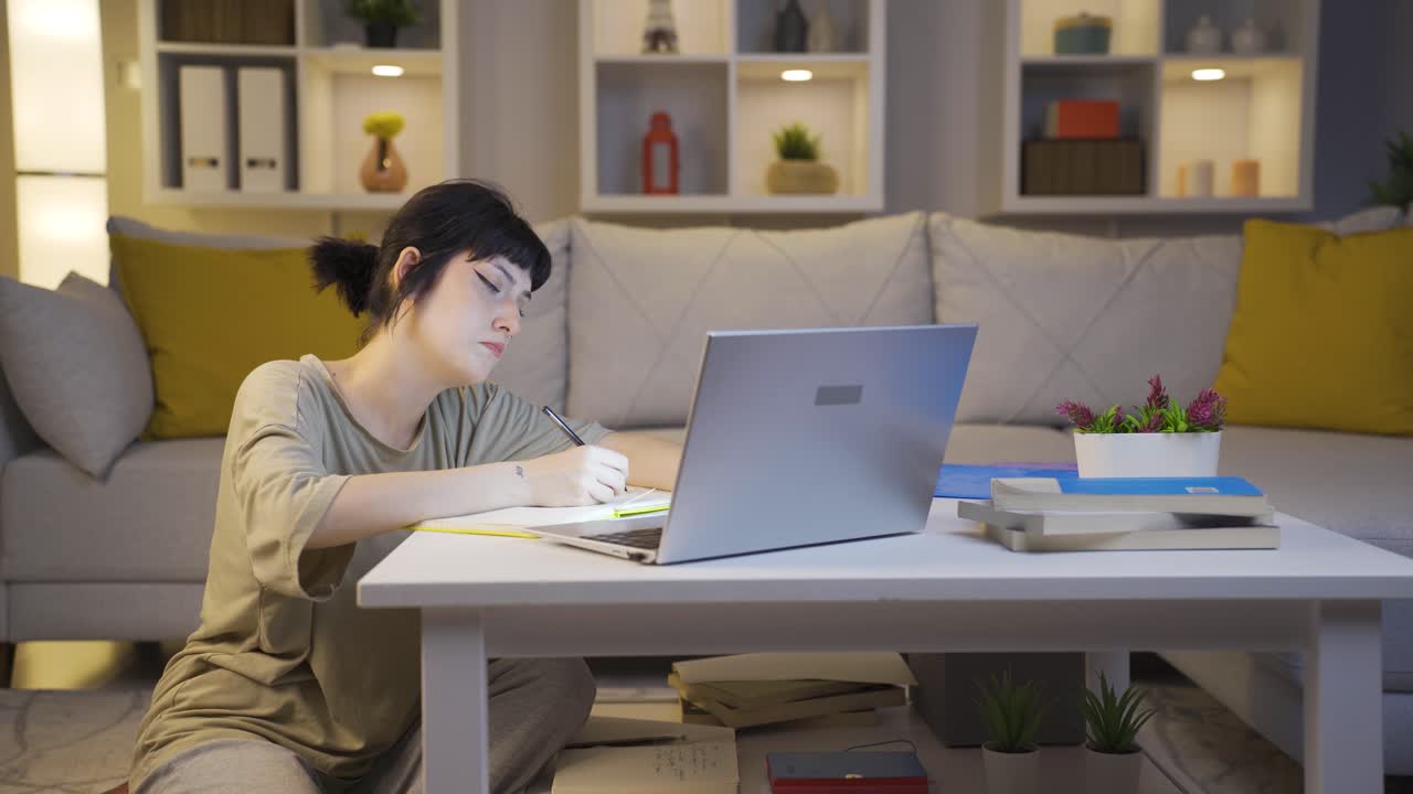 Unhappy young woman using laptop laptop at night. It's not in a good mood.