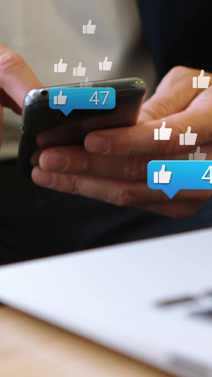 Animation of media icons over caucasian businessman using smartphone