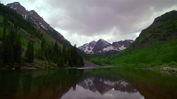 Aspen Snowmass Pyramid Peak Maroon Bells Wilderness 14ers mirror reflection Maroon Lake scenic landscape cloudy stormy sunset spring summer Elk Mountains Range Colorado Rocky Mountains