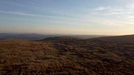 4K-Aerial-Drone-shot-Moving-Over-Grass-Mountain-Landscape-During-Sunset-With-Blue-Sky-in-Brecon-Beacons,-UK