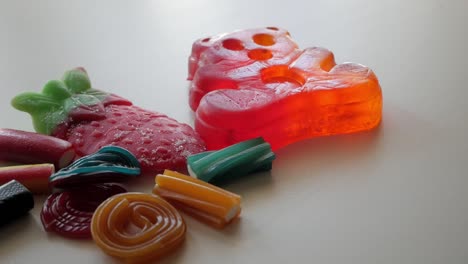 wide panning movement about mixed jellies on a table in studio enviroment at home, spain