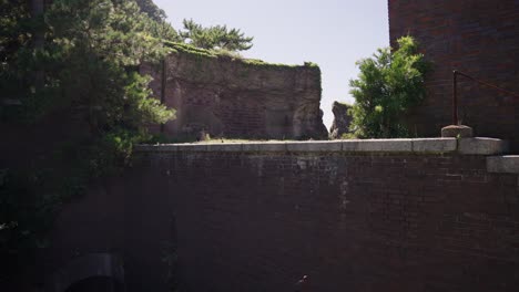 seaside fort of tomogashima island, pan over red brick ruins, japan