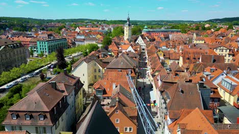 4k aerial drone video of the historic herrieder clock tower in the old town area of downtown ansbach, germany