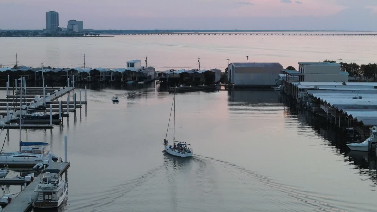 Tourist Boat Navigating On The River With Stilt Houses At Sunset. high angle