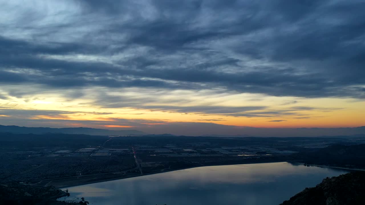 Hyper-Lapse drone 4k night image looking over Perris Lake as the sun sets.