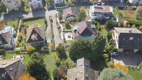 drone top view: residential area in a lausanne neighbourhood, town: houses, buildings, roads and trees in the capital city of vaud, switzerland