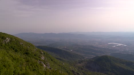 Locked-off-view-high-above-with-mountain-range-in-distance