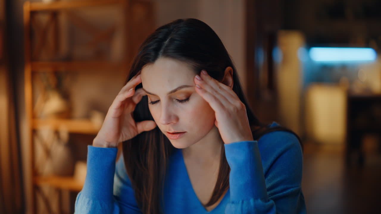 Furious woman yelling cellphone at night living room closeup. Angry lady call