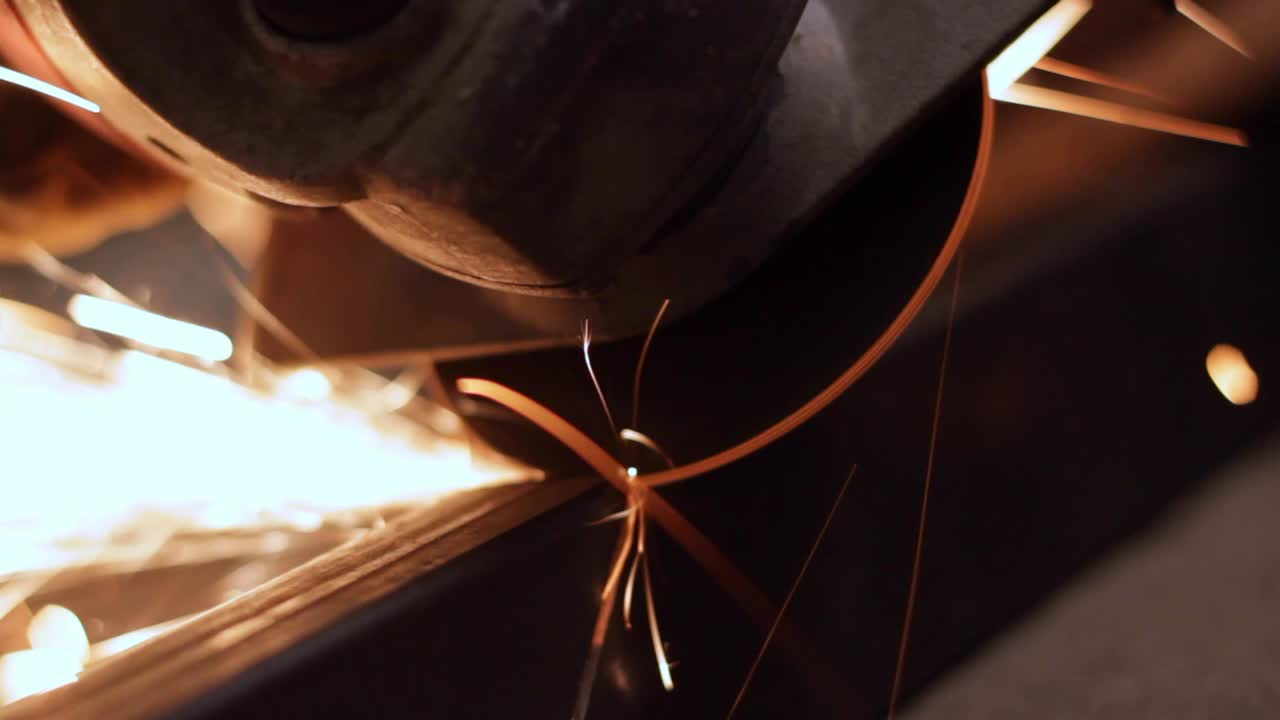 Close up of saw grinder cutting iron precisely, closeup