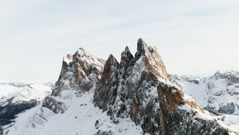 aerial shot of stunning peaks in the dolomites in winter on a bright cloudy day