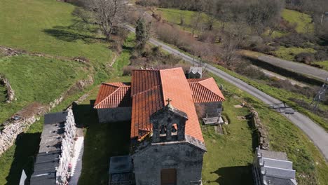 Drone-descends-to-establish-front-of-Church-of-Madanela-de-Cerdeira-in-San-Xoan-de-Rio,-Ourense,-Galicia,-Spain