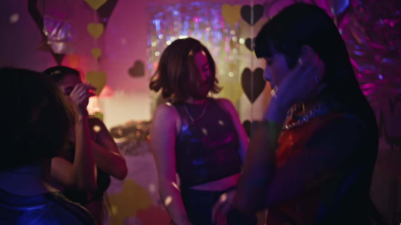 Party girls embracing dance floor enjoying weekend night in club. Happy women