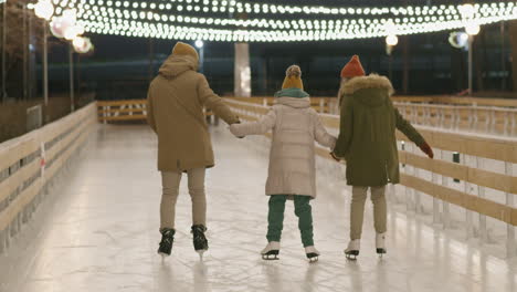 family ice skating at night