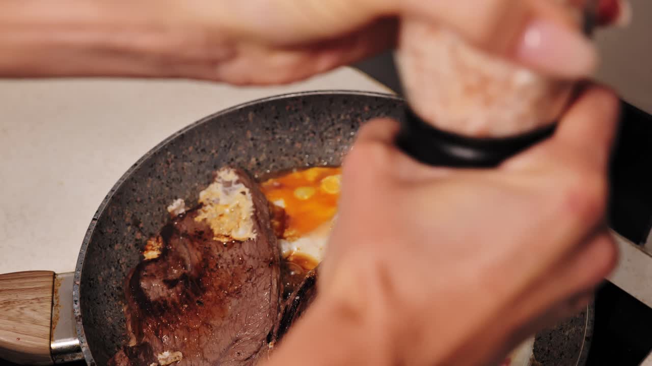Close view of salting meat shows fragile food supply and control in home kitchen