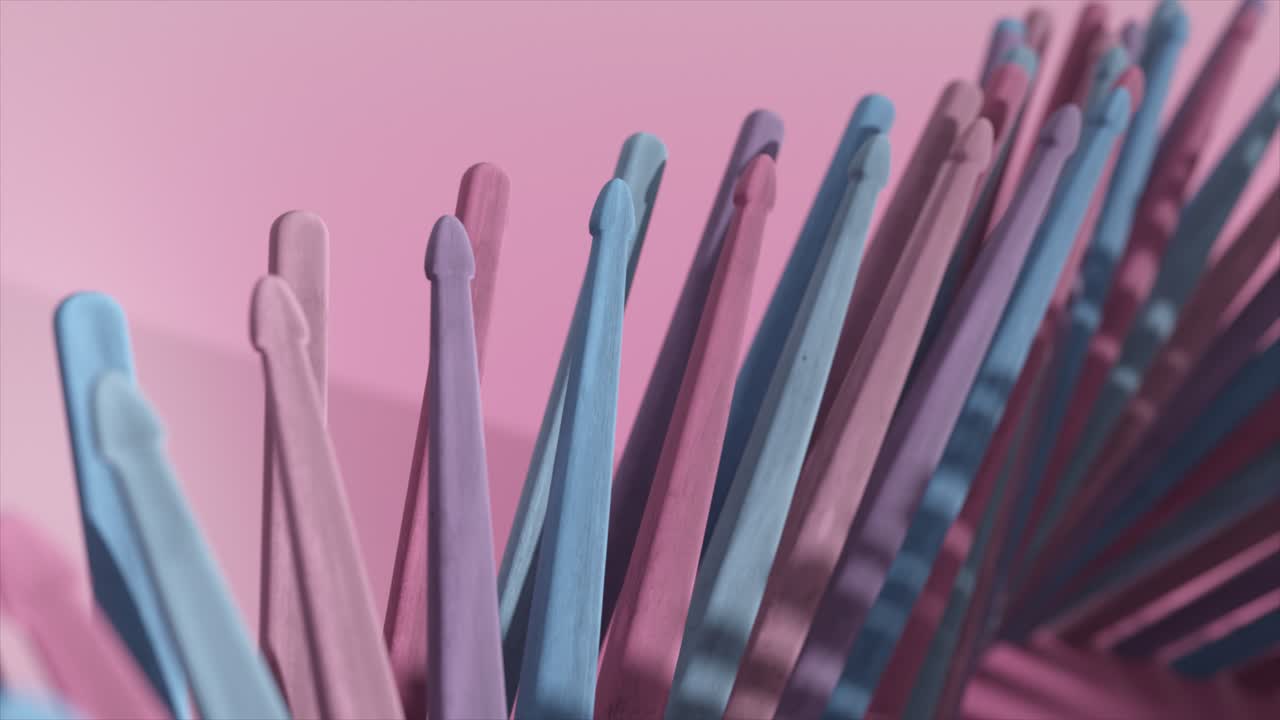 bastones de tambor abstractos y coloridos sobre un fondo rosado